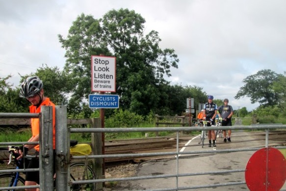 Cyclists dismount to cross the railway line